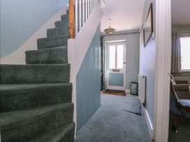 A hallway with staircase and door at The Lock House in Gloucester