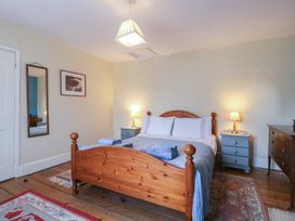 A bedroom with a bed and nightstands at The Lock House in Gloucester