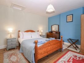 A bedroom with a bed and bedside table at The Lock House in Gloucester