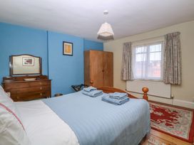 A bedroom with a bed and wardrobe at The Lock House in Gloucester