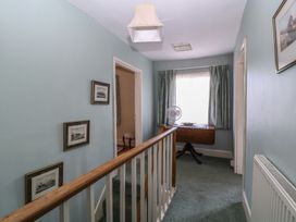 A hallway with a railing and photographs at The Lock House in Gloucester