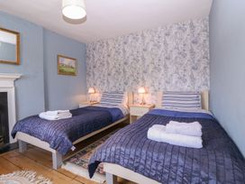 A bedroom with two beds and a mirror at The Lock House in Gloucester