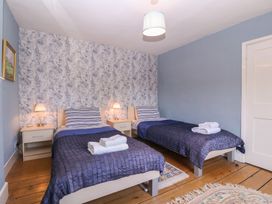 A bedroom with two beds and bedside tables at The Lock House in Gloucester