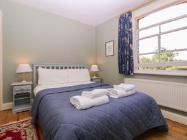 A bedroom with a bed and bedside tables at The Lock House in Gloucester