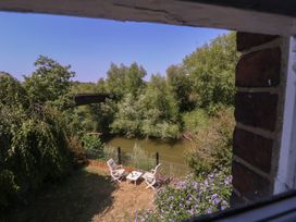 A view of a river with trees and chairs at The Lock House in Gloucester