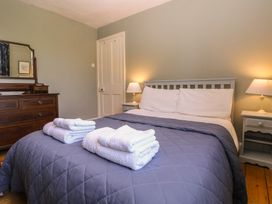 A bedroom with a bed and dresser at The Lock House in Gloucester