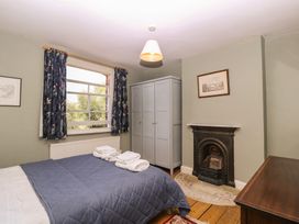A bedroom with a bed and wardrobe at The Lock House in Gloucester