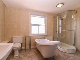 A bathroom with a bathtub, shower, toilet, and sink at The Lock House in Gloucester