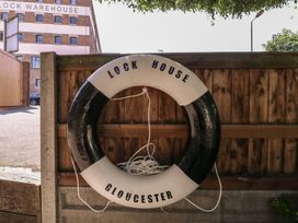 A lifebuoy mounted on a wooden fence at The Lock House in Gloucester