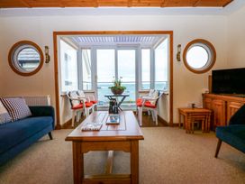 A living room with a sofa and coffee table at Min Y Traeth in Bull Bay