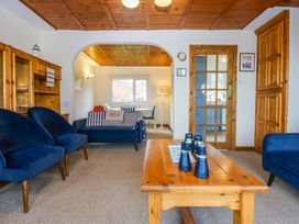 A living room with seating and a coffee table at Min Y Traeth in Bull Bay