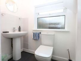 A bathroom with a sink and toilet at Min Y Traeth Bull Bay