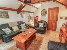 A living room with sofas and a coffee table at Piggery Cottage Wigton
