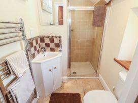 A bathroom with a shower and sink at Piggery Cottage in Wigton