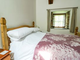 A bedroom with a bed and window at Bythyn Ddol Hafod in Capel Curig