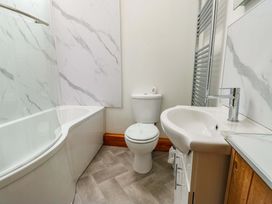 A bathroom with a bathtub, toilet, and sink at Bythyn Ddol Hafod in Capel Curig