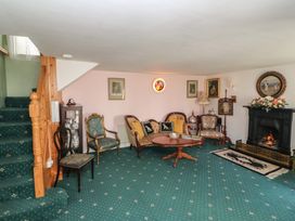 A living room with furniture including a sofa and fireplace at The Farmhouse in Dunmanway, County Cork