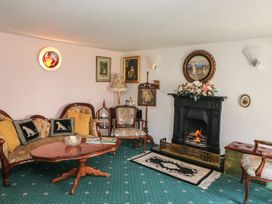 A living room with a fireplace and seating area at The Farmhouse in Dunmanway, County Cork