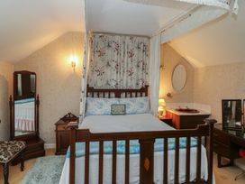 A bedroom with a bed and a dressing table at The Farmhouse in Dunmanway, County Cork