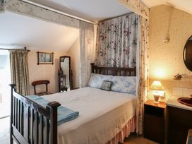 A bedroom with a bed and lamp at The Farmhouse in Dunmanway, County Cork