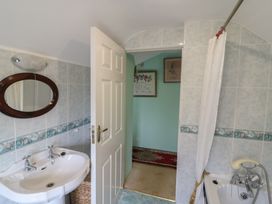 A bathroom with a wash basin and a bathtub at The Farmhouse in Dunmanway, County Cork