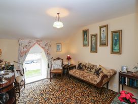 A living room with a sofa and armchair at The Farmhouse in Dunmanway, County Cork