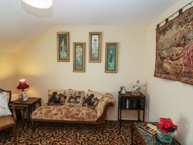 A snug with a sofa and wall art at The Farmhouse in Dunmanway, County Cork