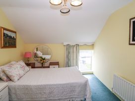 A bedroom with a bed and a mirror at The Farmhouse in Dunmanway, County Cork