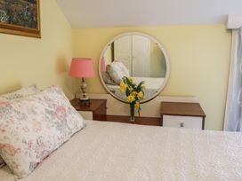 A bedroom with a bed and a mirror at The Farmhouse in Dunmanway, County Cork