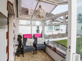 A conservatory with seating and decorative features at The Farmhouse in Dunmanway, County Cork