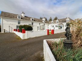 An outdoor view of a building with a statue at The Farmhouse in Dunmanway, County Cork