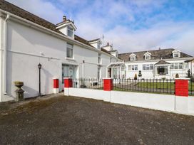 An outdoor area with a building and fence at The Farmhouse in Dunmanway, County Cork