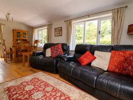 A living room with a sofa and dining table at The Lambing Shed Dyserth near Prestatyn