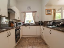 A kitchen with oven microwave and sink at The Lambing Shed near Dyserth