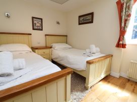 A bedroom with two single beds and a drawer at The Lambing Shed in Dyserth near Prestatyn