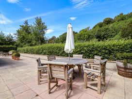An outdoor seating area with a table and chairs at The Lambing Shed Dyserth near Prestatyn