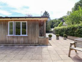 An outdoor area with a wooden wall and potted plants at The Lambing Shed Dyserth near Prestatyn