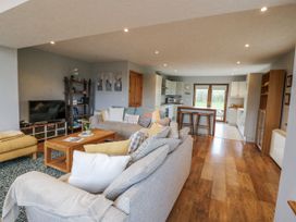 A living room with a sofa and coffee table at Lough Cluhir Cottage in Union Hall, County Cork