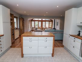 A kitchen with cabinets and an island at Lough Cluhir Cottage, Union Hall, County Cork