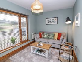 A living room with a sofa and a coffee table at Lough Cluhir Cottage, Union Hall, County Cork