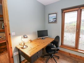 An office with a desk and computer monitor at Lough Cluhir Cottage, Union Hall, County Cork