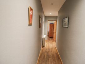 A hallway with artwork on the walls at Lough Cluhir Cottage, Union Hall, County Cork