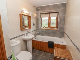 A bathroom with a bathtub and sink at Lough Cluhir Cottage, Union Hall, County Cork