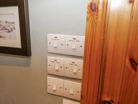 A switch panel for immersion, jacuzzi bath, water pump, and towel rail at Lough Cluhir Cottage in Union Hall, County Cork