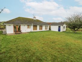 A house with a shed and table in the garden at Lough Cluhir Cottage, Union Hall, County Cork