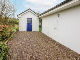 An outdoor area with a gravel pathway and a side building at Lough Cluhir Cottage, Union Hall, County Cork