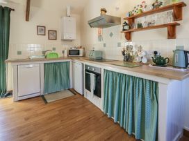 A kitchen with appliances and utensils at Lily Cottage Caeathro near Caernarfon