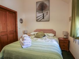 A bedroom with a bed and towels on it at Lily Cottage in Caeathro near Caernarfon