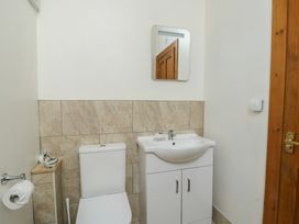 A bathroom with a toilet and sink at Lily Cottage in Caeathro near Caernarfon