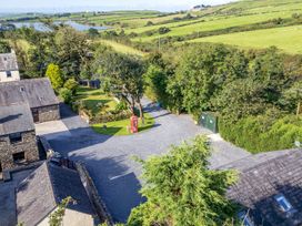 An outdoor area with buildings and a garden at Hill Side Barn in Pennington near Ulverston